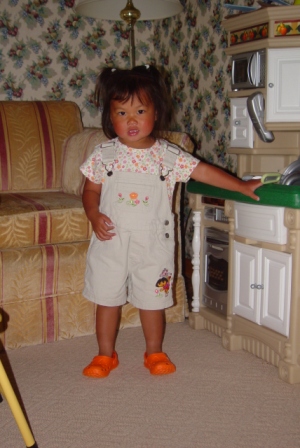 Kasen dressed for school in Dora Overalls